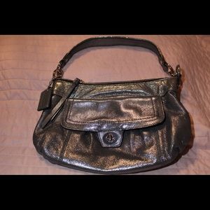 Cute Coach Purse.  It’s a metallic pewter/silver color.  Gently used